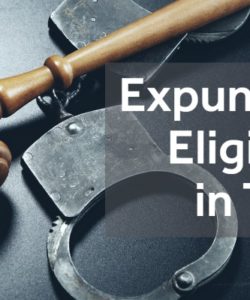 gavel and metal handcuffs on grey table with the text "expunction eligibility in Texas"