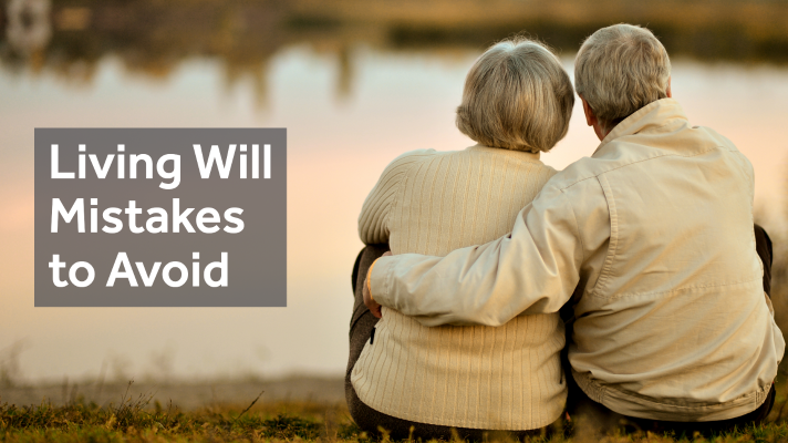 Text :Living will mistakes to avoid. Retired couple sitting together at the edge of a pond looking out to a sunset. 