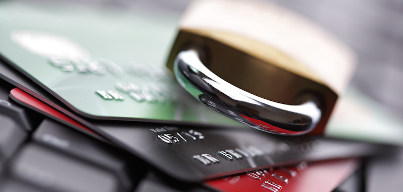 Close up of a pile of credit cards with a lock on top