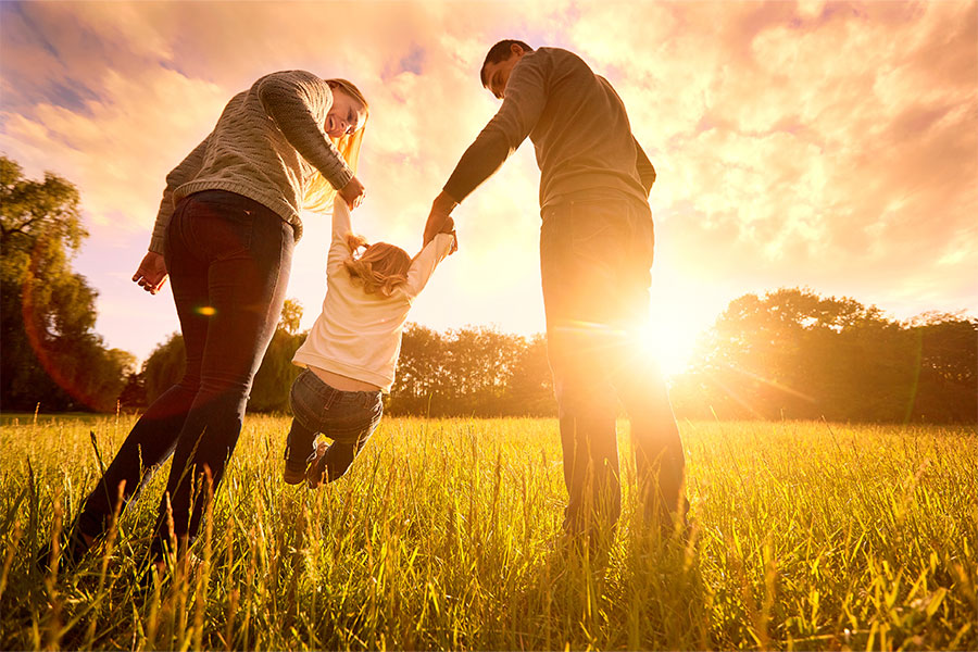 Mother and father with daughter outside