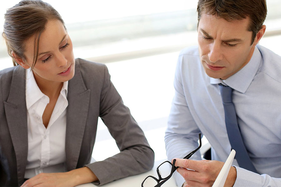 Man and woman in an office reviewing details