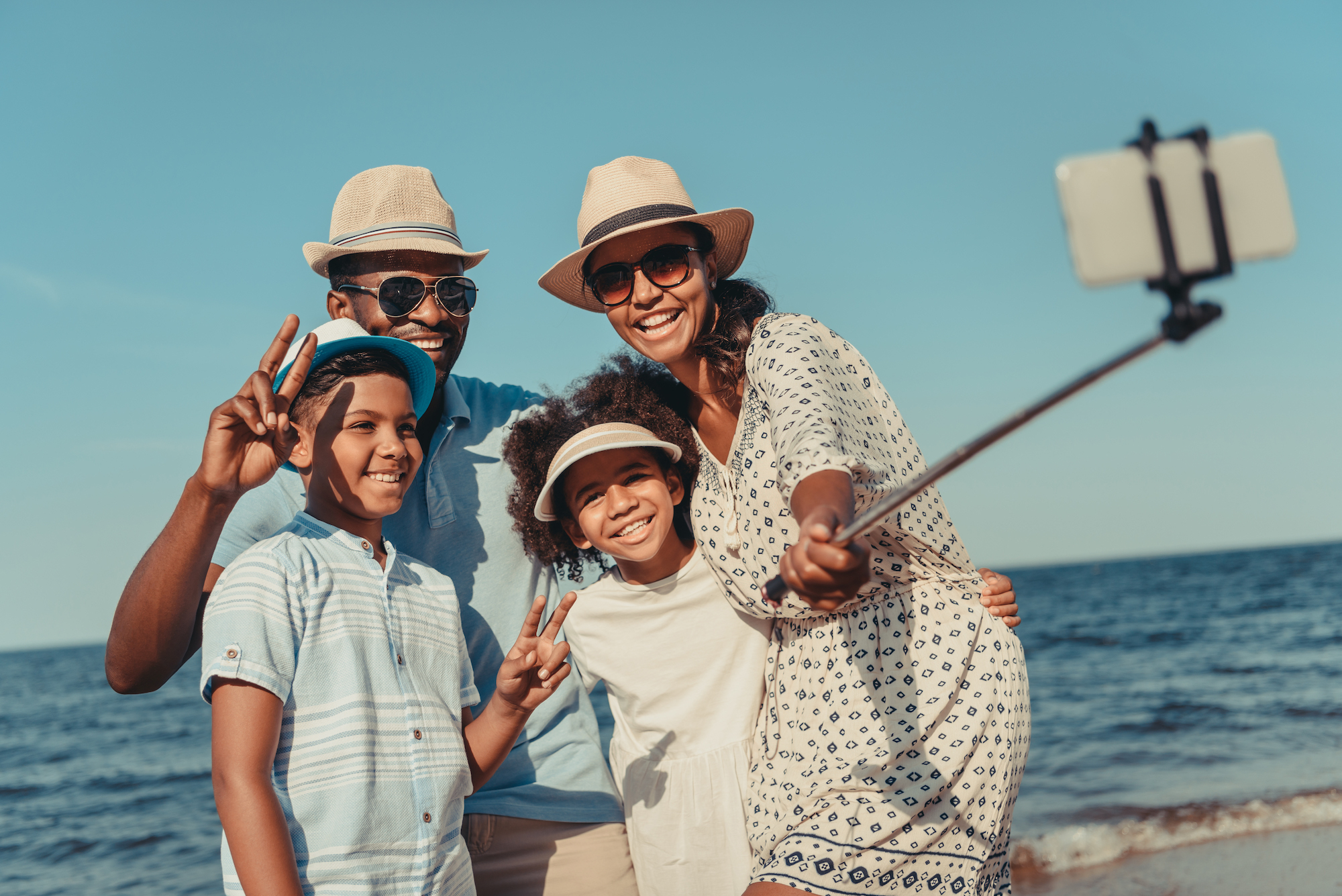 Family taking a photo on a beach vacation