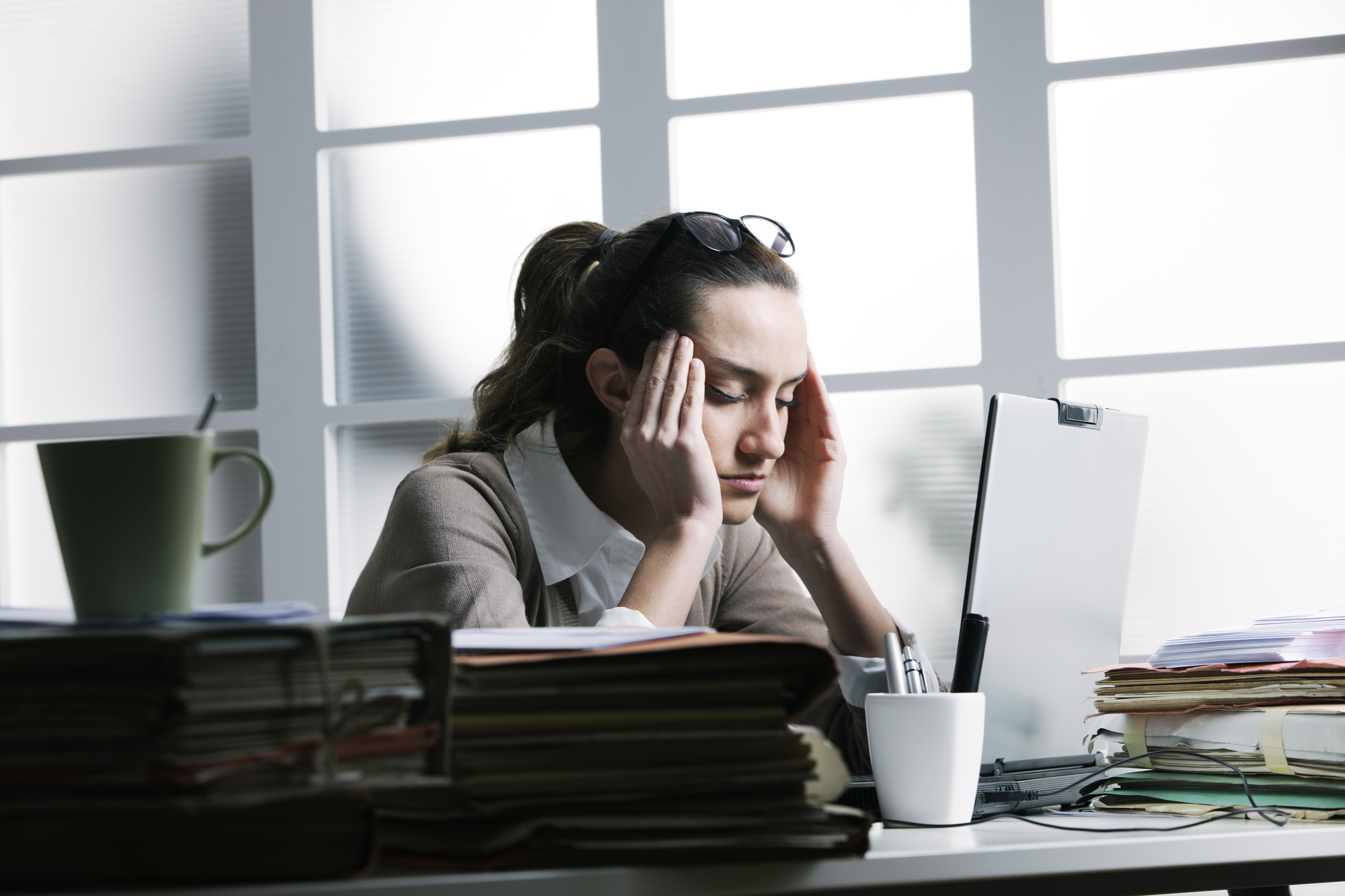 Stressed woman sitting at an office desk