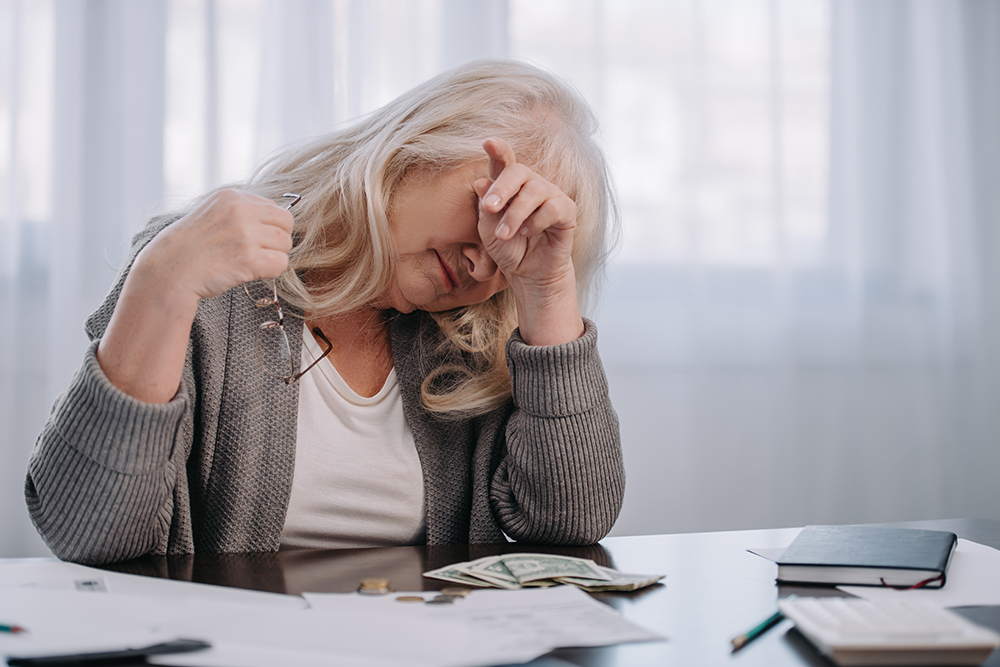 Woman sitting at a desk in distress